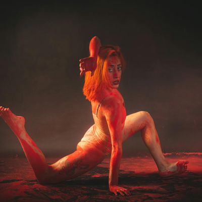 Person in the middle of a fluid yoga transition.