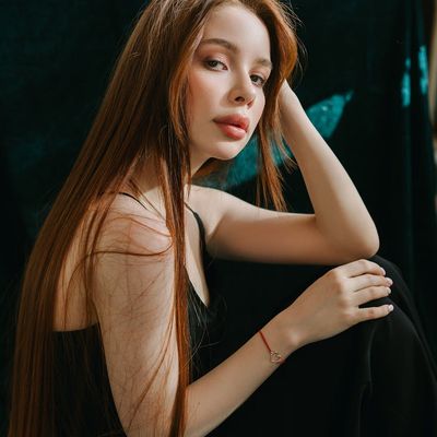 Person sitting peacefully with eyes closed.